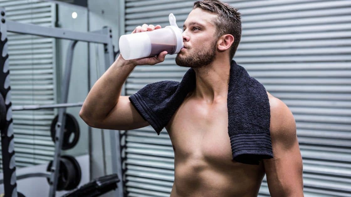 Male athlete drinking whey protein