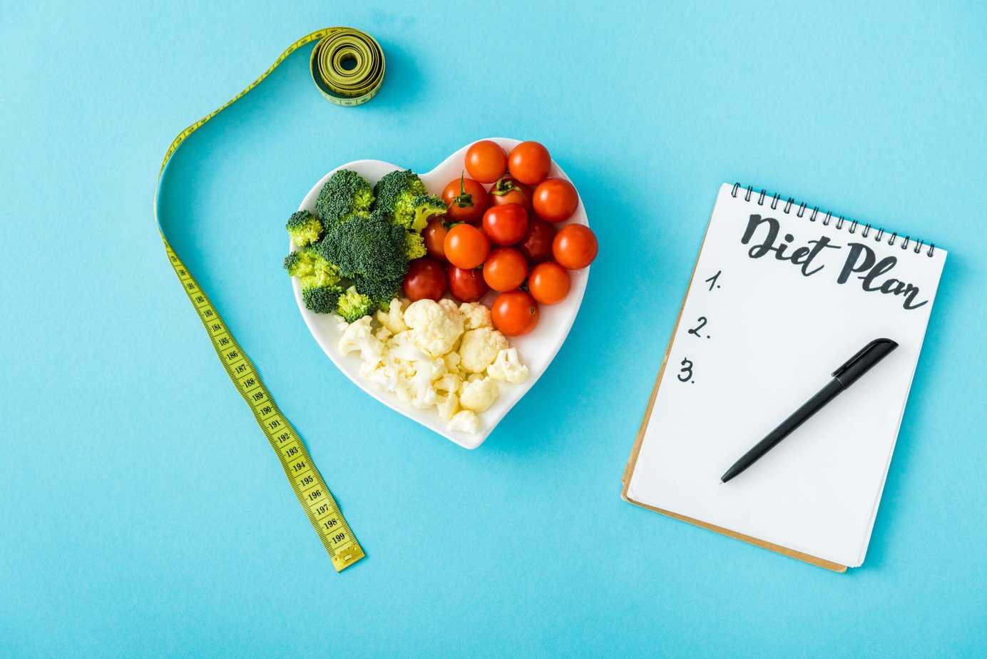 Top view of tasty vegetables on heart-shape plate